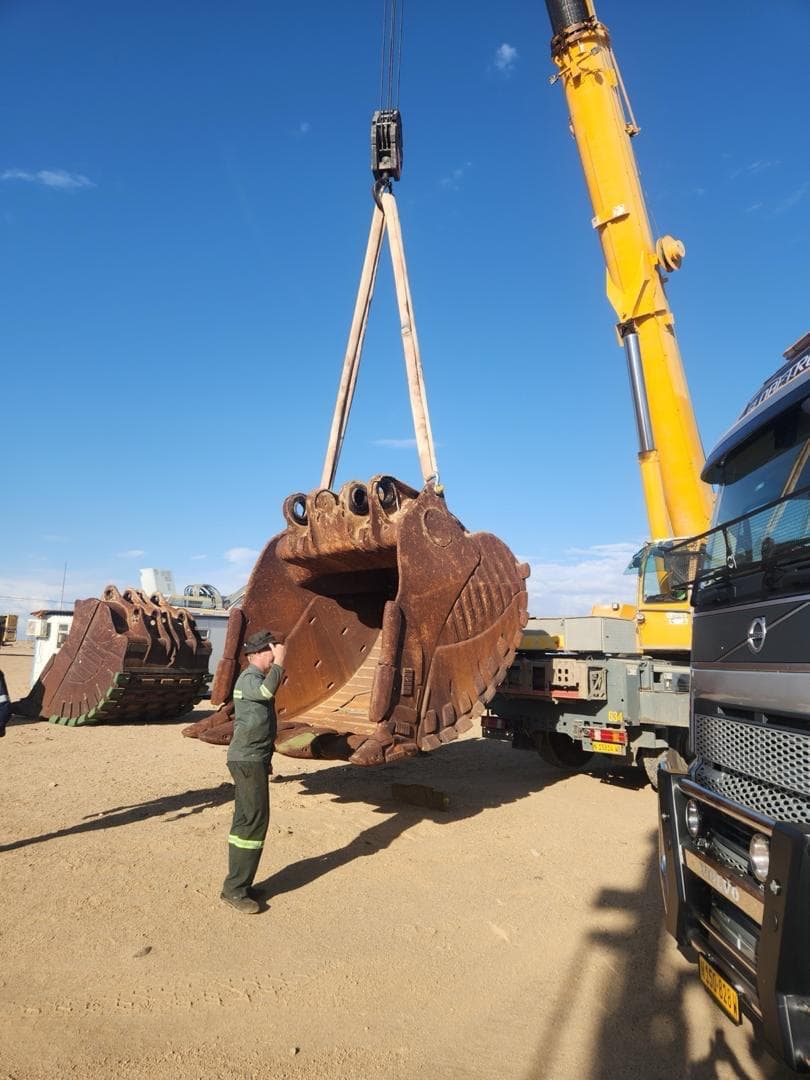 Vertical photo showing heavy equipment in active field conditions