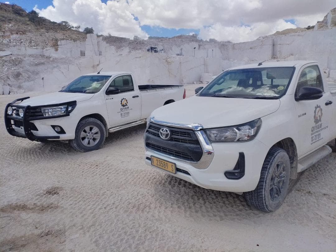 Qiyam support vehicles stationed in an active quarry environment